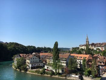 Residential district against clear blue sky