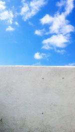 Scenic view of beach against blue sky