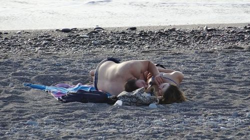 People relaxing on beach