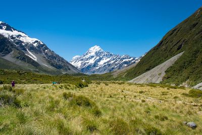 Scenic view of snowcapped mountains against blue sky