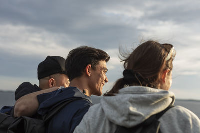 Friends sitting together at sea