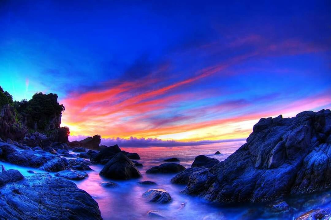 scenics, sunset, beauty in nature, tranquil scene, sky, tranquility, rock - object, rock formation, orange color, sea, nature, water, idyllic, cloud - sky, blue, horizon over water, rock, dramatic sky, cloud, non-urban scene