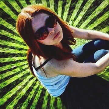 PORTRAIT OF YOUNG WOMAN WEARING SUNGLASSES