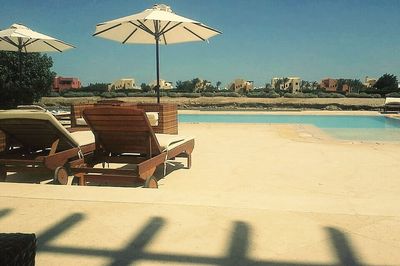 View of swimming pool on beach against clear sky