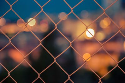 Full frame shot of chainlink fence during night