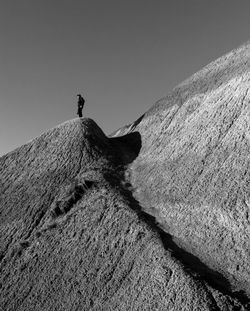 Low angle view of man standing on mountain