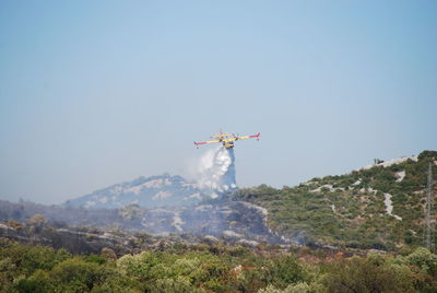 Low angle view of airplane flying against clear sky