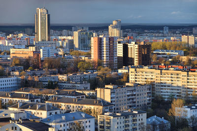 Aerial view of buildings in city against sky