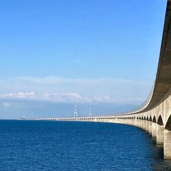 Scenic view of sea and big belt bridge against sky