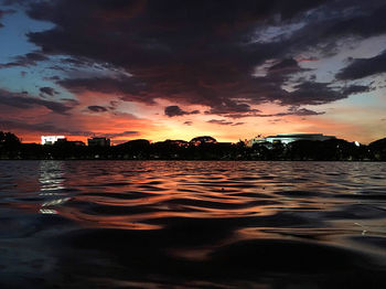 Scenic view of sea against dramatic sky during sunset