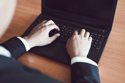 High angle view of man using laptop on table