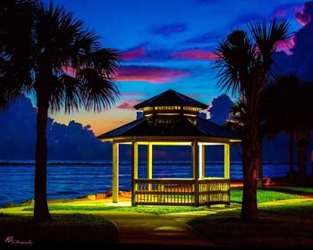 Built structure by sea against sky