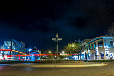 Illuminated city against sky at night