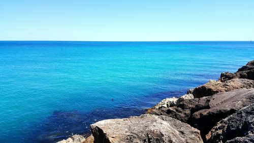 View of calm blue sea against clear sky