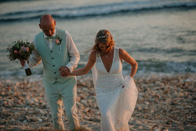 Wedding couple couple standing at sea shore