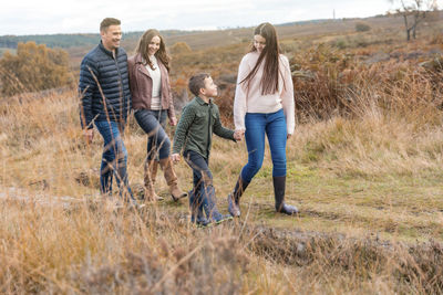 Rear view of friends standing on landscape