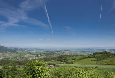 Scenic view of landscape against blue sky