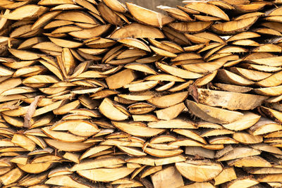 Texture of wooden planks stacked outdoors