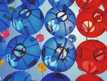 Low angle view of paper lanterns hanging against sky