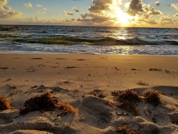 Scenic view of beach against sky during sunset