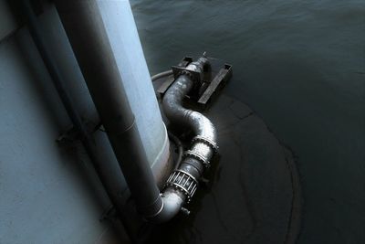 High angle view of metallic pipe in lake