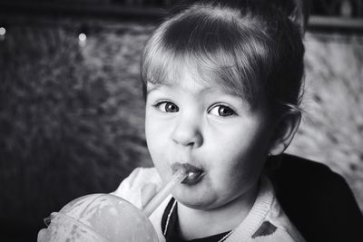 Close-up portrait of girl sipping drink