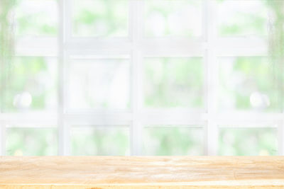 Wooden table seen through glass window