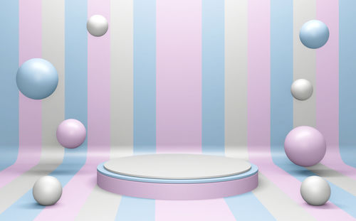 Close-up of multi colored balloons on table against wall