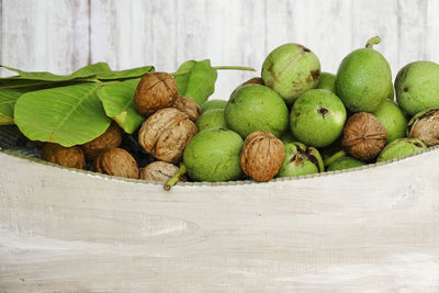 Close-up of walnuts and leaves in white box freshly harvested 