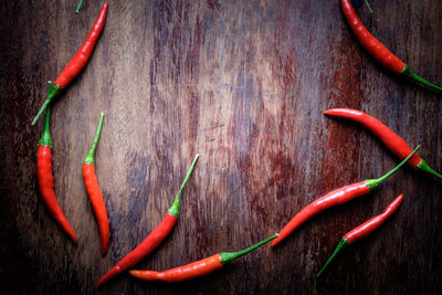 Close-up of red chili peppers on wood