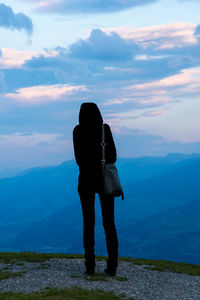 Rear view of man standing on mountain