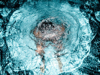 Digital composite image of person swimming pool