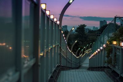 Illuminated bridge against sky at dusk