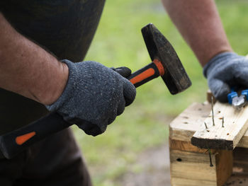 Close-up of man working on wood