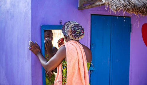 People standing against blue wall