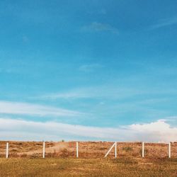 Scenic view of field against cloudy sky