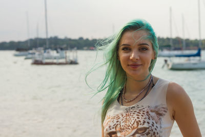 Portrait of woman against water