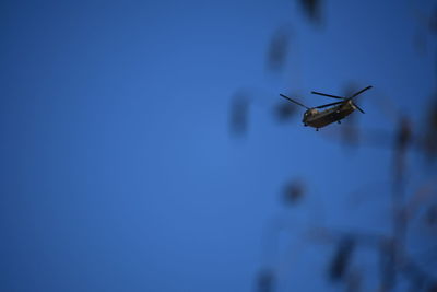 Low angle view of airplane flying against clear sky