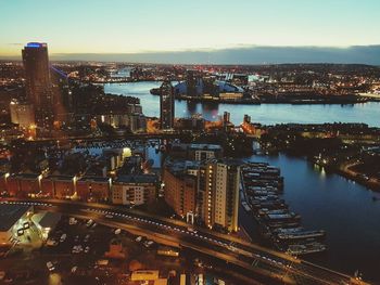 Aerial view of city lit up at sunset