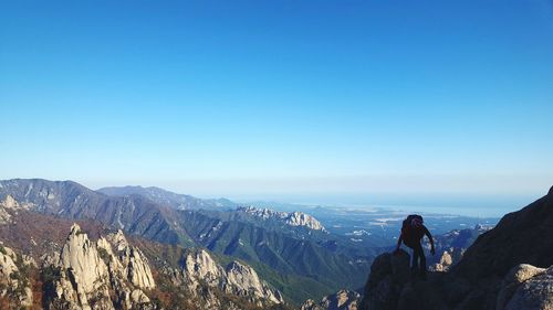 Scenic view of mountains against blue sky
