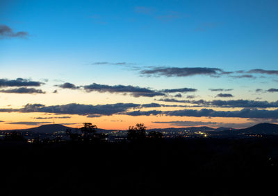 Silhouette landscape against romantic sky at sunset