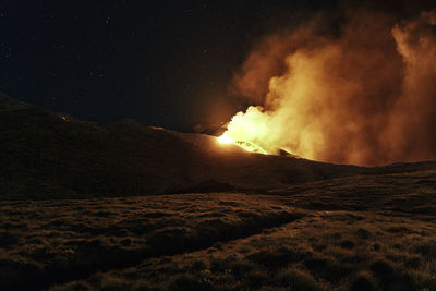 Scenic view of land against sky at night