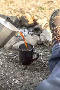 Low section of person wearing shoes on bonfire