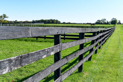 Fence on field against sky