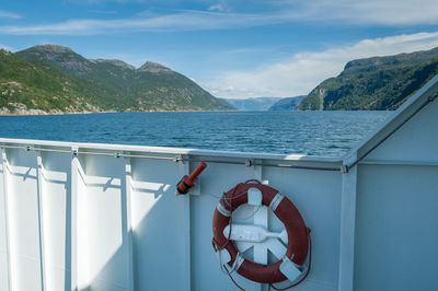 On a ferry crossing fjord. norway. view from hull opening at water and coastline with mountains. 