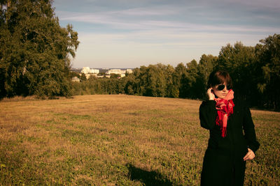 Woman standing on grassy field