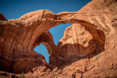 Red rock arch against sky