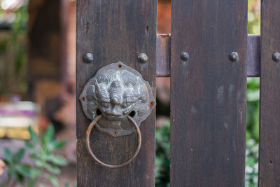 Close-up of old wooden post on fence