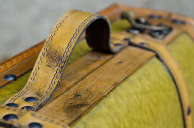 High angle view of leather handle on old suitcase