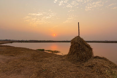 Scenic view of lake against sky during sunset